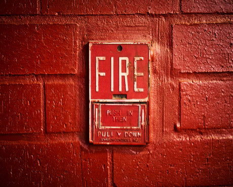 Where should fire extinguisher signs be placed?