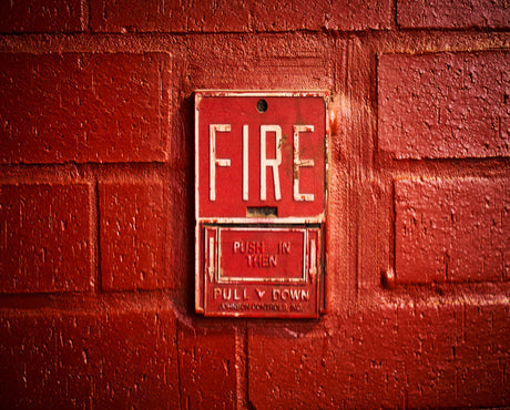 Where should fire extinguisher signs be placed
