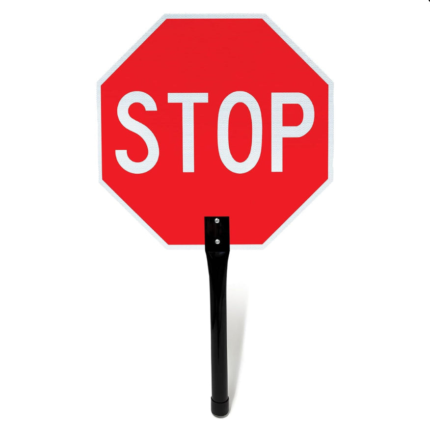 Red stop sign with a black stand on a white background