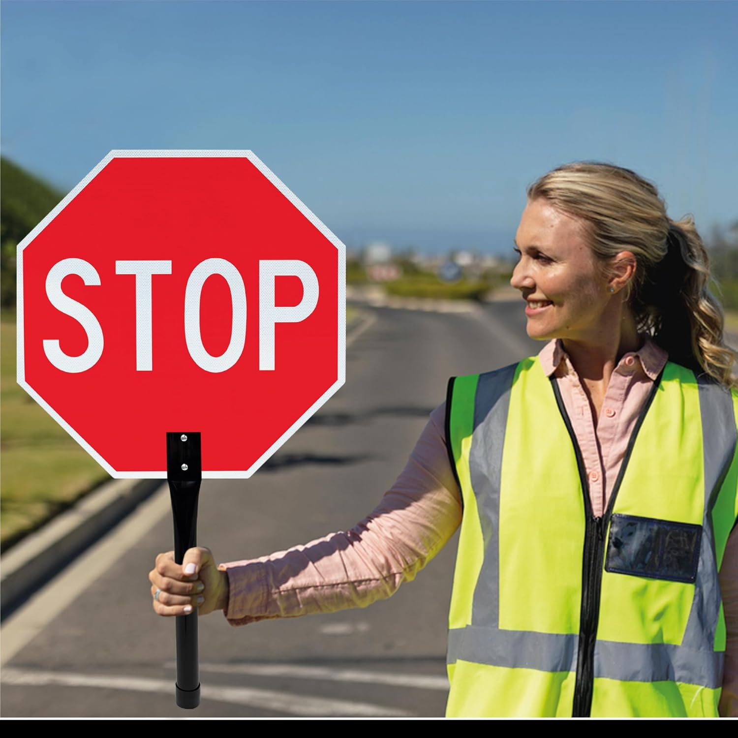 Two sides of a stop / slow paddle sign, one red with 'STOP' and one orange with 'SLOW', on white background.